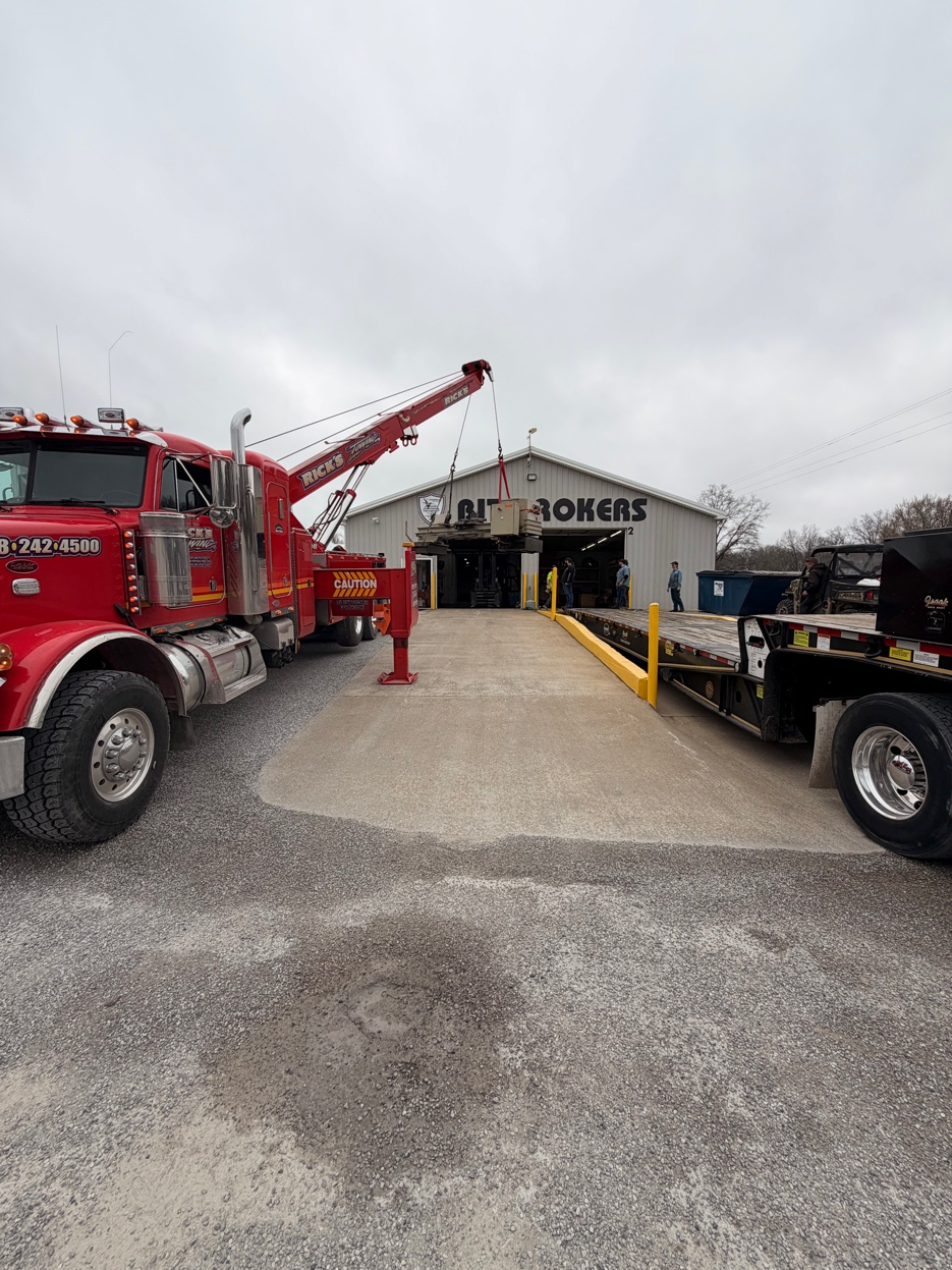 Rick's Towing crane placing heavy equipment