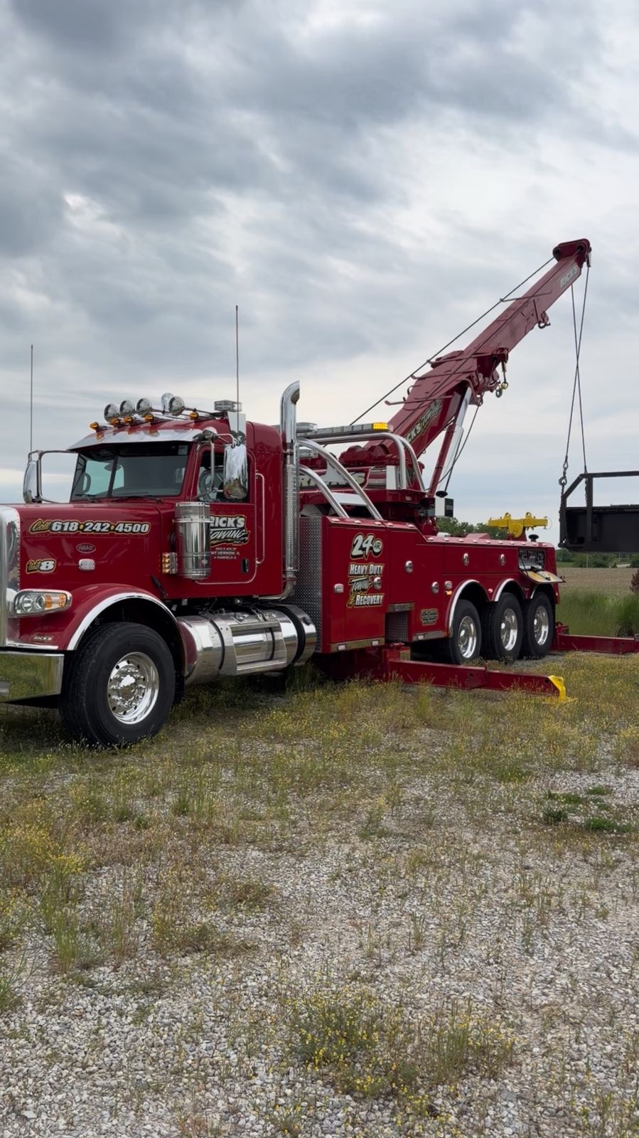 Rick's Towing Unit 8 Peterbilt heavy wrecker with boom raised and outriggers deployed